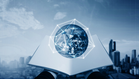 Hand opened book and global with network connection, modern city background.の写真素材