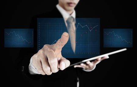 Businessman pointing raising graph screen. Business growth, investment and finance conceptの写真素材