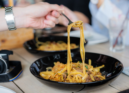 Spaghetti meat sauce. Hand using fork eating Spaghettiの写真素材