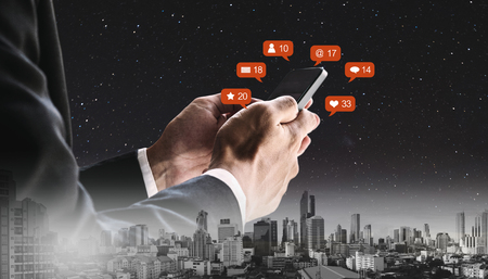 Double exposure, Businessman using mobile phone and notification iconsの写真素材