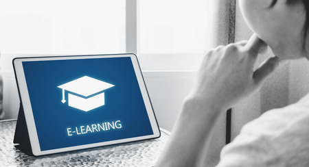 Online education, e-learning and e-book concept. a man using digital tablet for education at homeの写真素材