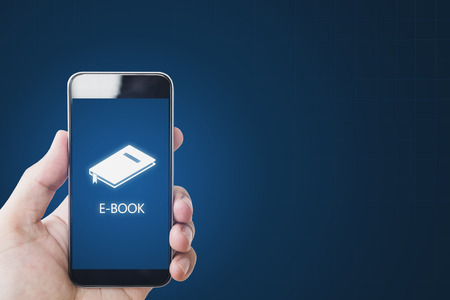 E-book on on mobile smart phone, hand using e-book on mobile device. Online education, e-learning and e-book conceptの写真素材