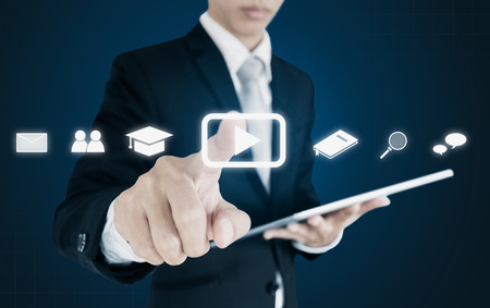 Online media business and application technology. Businessman pointing on media play iconsの写真素材