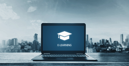 E-learning on computer laptop and city background. Online education, e-learning and e-book conceptの写真素材
