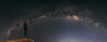 Night sky full of star and milky way, with traveller with backpack enjoying beautiful sky at nightの写真素材