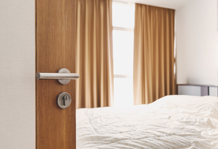 Close-up door opened, entering to bedroom in the morningの写真素材