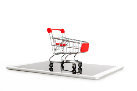 Empty shopping cart on digital tablet, isolated on white background. Online shoppingの写真素材