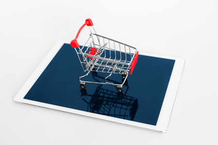 Empty shopping cart on digital tablet, on white background. Online shoppingの写真素材