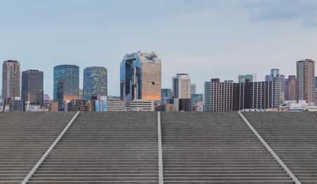 Panoramic city skyline and buildings with concrete stairway