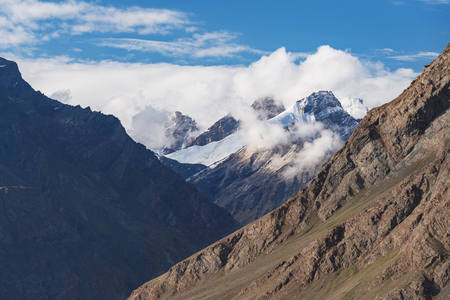 Mountains ridge landscape with blue sky and white cloudsの写真素材