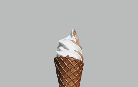 Soft cream ice cream with chocolate waffle cone, isolated on gray backgroundの写真素材