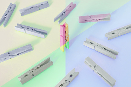 Unique, individuality, leadership and think different concept. One wooden clip difference with other clips, with contrast vintage pastel coloredの写真素材