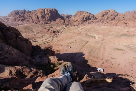 Travelling, hiking and adventurous in desert Middle-East. Traveler enjoying high angle view of desert landscape in Jordanの写真素材