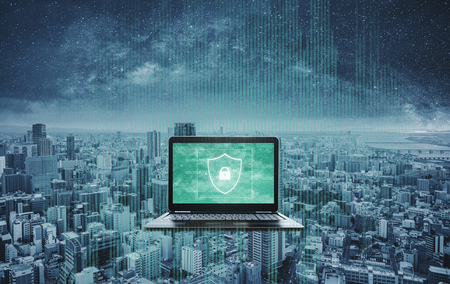 Digital data security system and protection on computer laptop. Computer laptop with shielding and safety system on screen, and futuristic backgroundの写真素材
