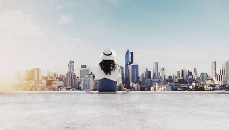 Traveling in Bangkok city, Thailand. Young traveler in white hat and cloth looking at Bangkok city...
