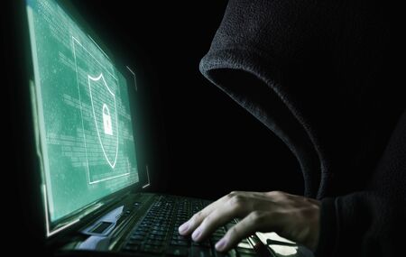Digital data security system and protection. Anonymous hacker try to hacking on computer laptopの写真素材