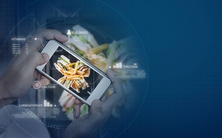Food Nutrition Scanning Technology, and Healthy eating Lifestyles. a man using mobile smart phone checking nutrition factsの写真素材