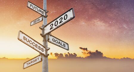 New year concepts on directional road sign, with sunrise sky backgroundの写真素材