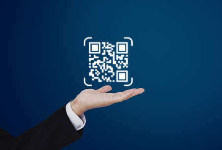 Hand holding QR code on hand. QR code scanning payment and verification technologyの写真素材