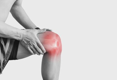 Joint pain, Arthritis and tendon problems. a man touching nee at pain point, on white backgroundの写真素材