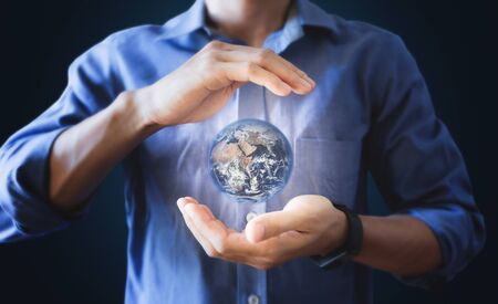 Earth holding by a man hand.の写真素材