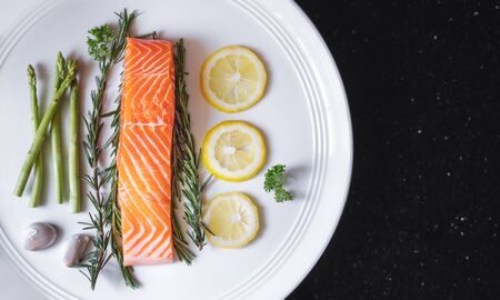 Raw fresh salmon fillet with herbs and ingredients