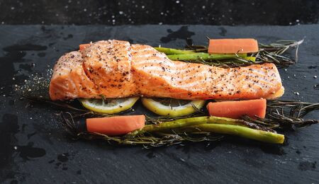 Grilled Salmon baked fillet steak, with lemon, Asparagus, Rosemary and Carrotの写真素材