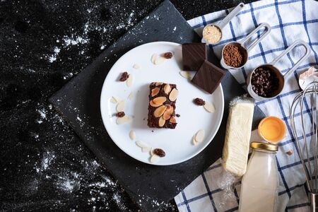 Chocolate brownies on white dish, surround with ingredients. Homemade dessert and bakeryの写真素材