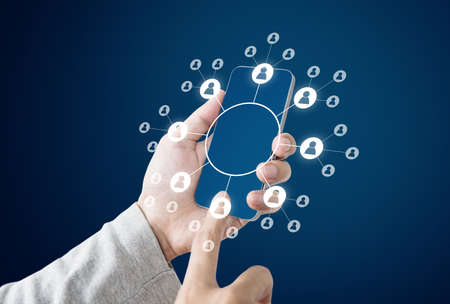 Businessman holding mobile smart phone with social networking icons