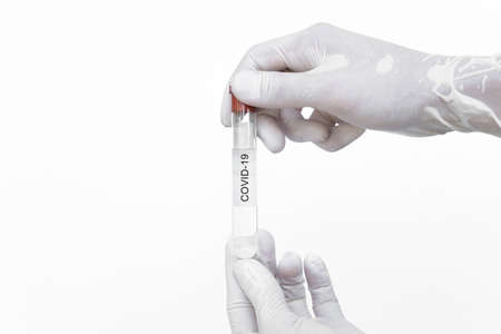 Covid-19 vaccine. Hand holding corona virus immune vaccine, isolated on white backgroundの写真素材