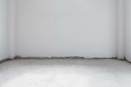 Under renovation room, concrete cement floor with white wallの写真素材