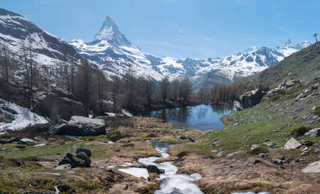 Snow mountain Matterhorn with lake and forest in summer, Switzerlandの写真素材
