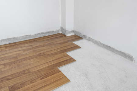 Wooden flooring installation and renovation, with base cement floor. Under constructionの写真素材