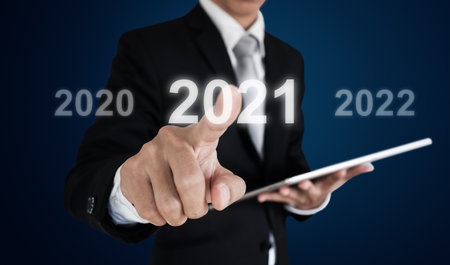 Businessman pressing on 2021の写真素材