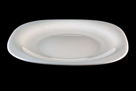 white plate on a black backgroundの写真素材