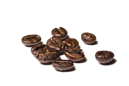 a handful of coffee beans on white backgroundの写真素材