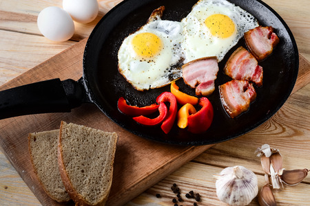 Fried eggs in a frying pan in a ruralの写真素材