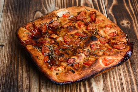 Focaccia with dried tomatoeson on the tableの写真素材