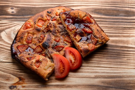 Focaccia with dried tomatoeson on the tableの写真素材