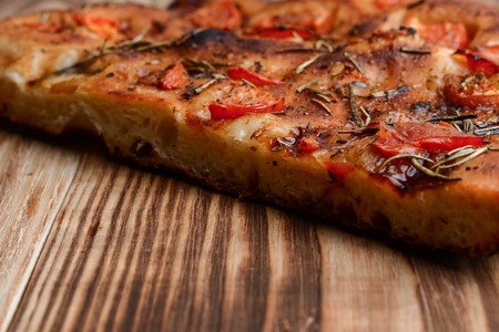 Focaccia with dried tomatoeson on the tableの写真素材