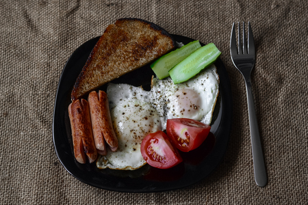 fried egg sausages tomatoes for healthy breakfastの写真素材