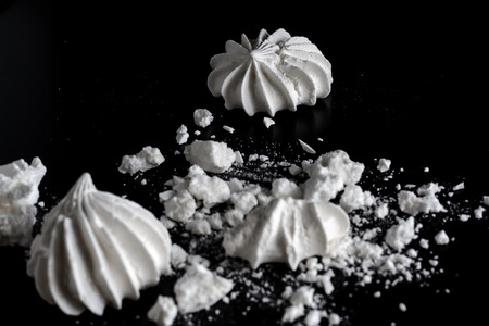 French meringue crumbs on a black backgroundの写真素材