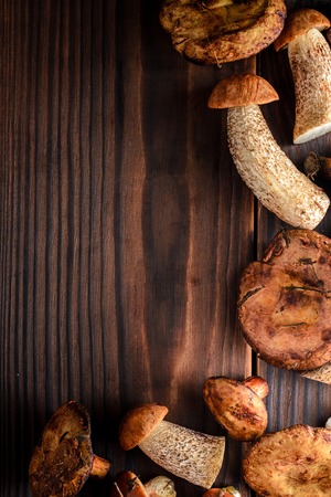mushrooms on a wooden background with space for textの写真素材