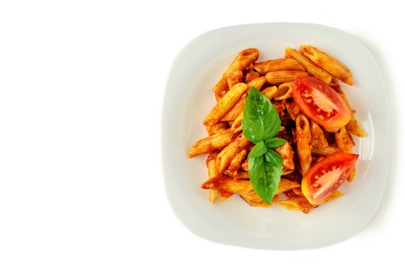 Penne pasta with bolognese sauce, tomato and basil on plate isolated. copy spaceの写真素材