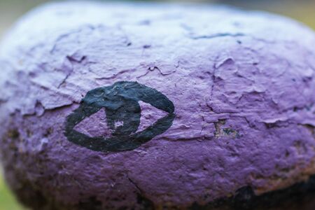 A colored stone with a painted eye close upの写真素材