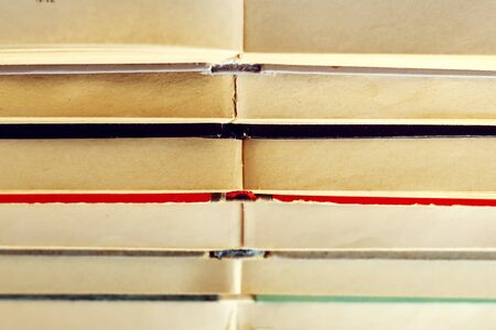 stack of old books lying on top of each other. A pattern from books as a backgroundの写真素材