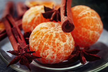Mandarin, cinnamon sticks and anise on a plate. Christmas compositionの写真素材
