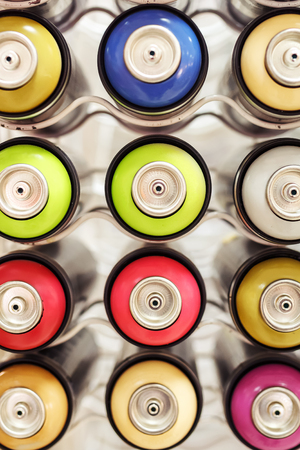 rows of colored paint cans in the storeの写真素材
