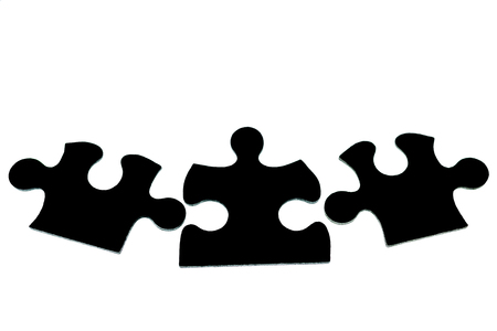 three black pieces of puzzle on a white background isolate. The concept of unity, teamworkの写真素材