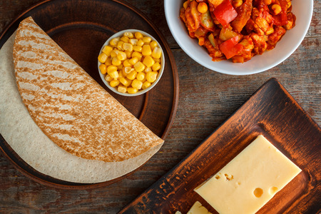 ingredients for quesadilla, burito, taco, on a wooden table. Top viewの写真素材